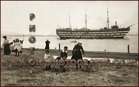 Grays Thurrock : Children playing on the beach at Grays with the Exmouth training ship in the Thames [c.1906]